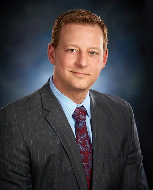A headshot of Attorney Nathan J. Dineen wearing a suit.