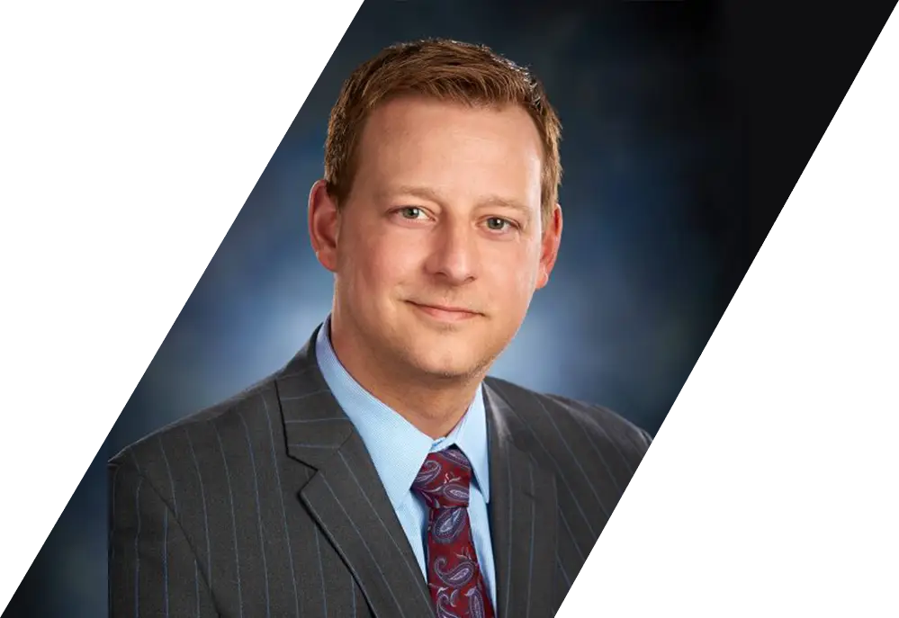 A headshot of Attorney Nathan J. Dineen wearing a suit.