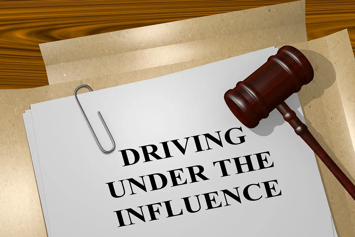 A wooden gavel is on top of a legal paper with the words reading 'Driving Under The Influence'.