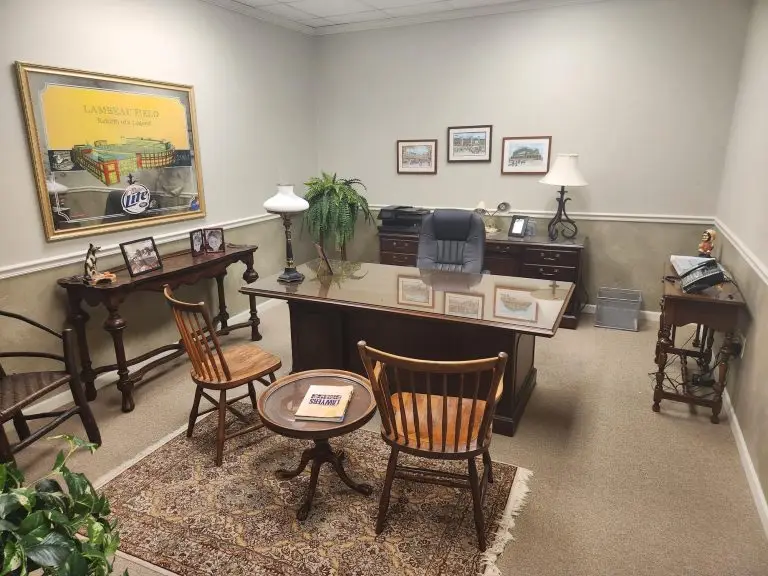 Judge's chambers with wooden chairs and a center table.